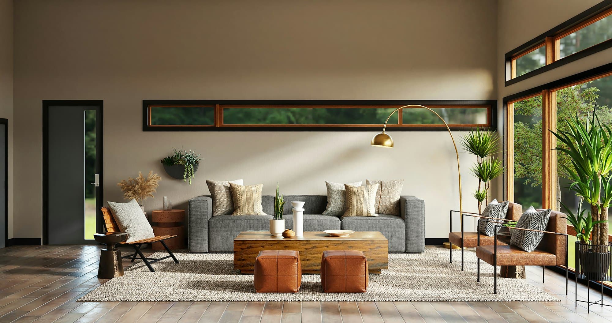 A warm, sunlit modern living room — a grey sofa layered with cushions, a wood coffee table, leather poufs, and tall potted plants beside floor-to-ceiling windows